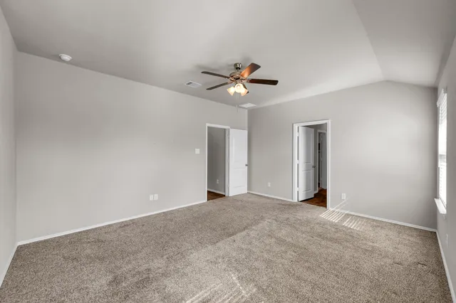 a view of an empty room with a ceiling fan
