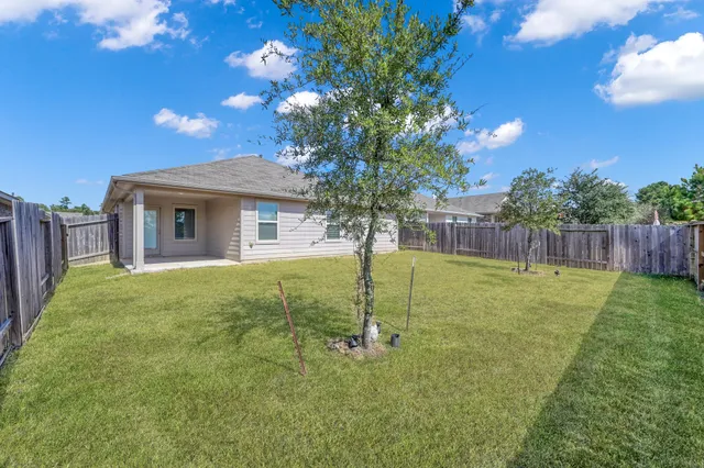 a swimming pool with outdoor seating and yard