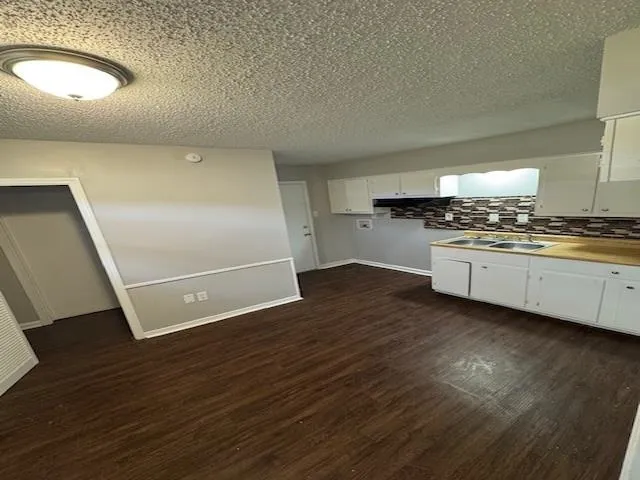 a kitchen with a sink a stove and cabinets