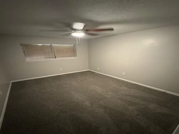 an empty room with a empty space and windows