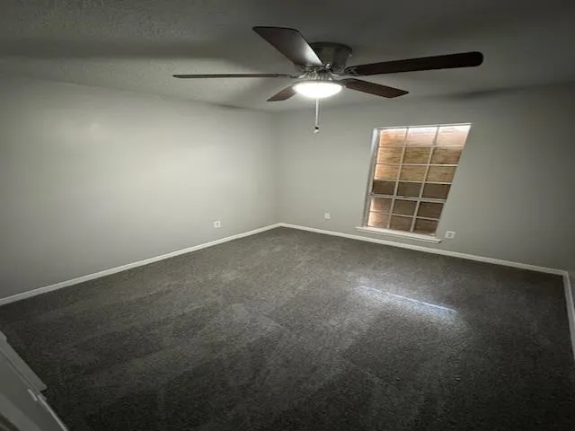 an empty room with a empty space and a ceiling fan