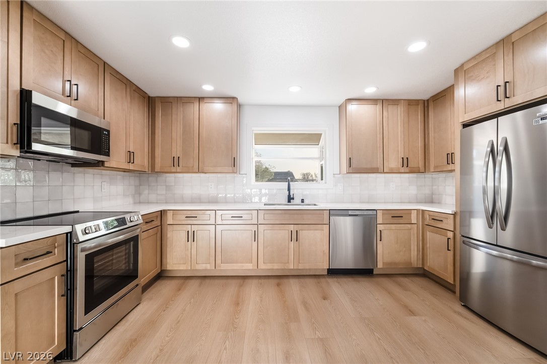 429 Crestway Road Henderson, NV 89015 - Photo 18 of 56 Culinary creations come to life in this kitchen, featuring recessed lighting and abundant cabinetry.