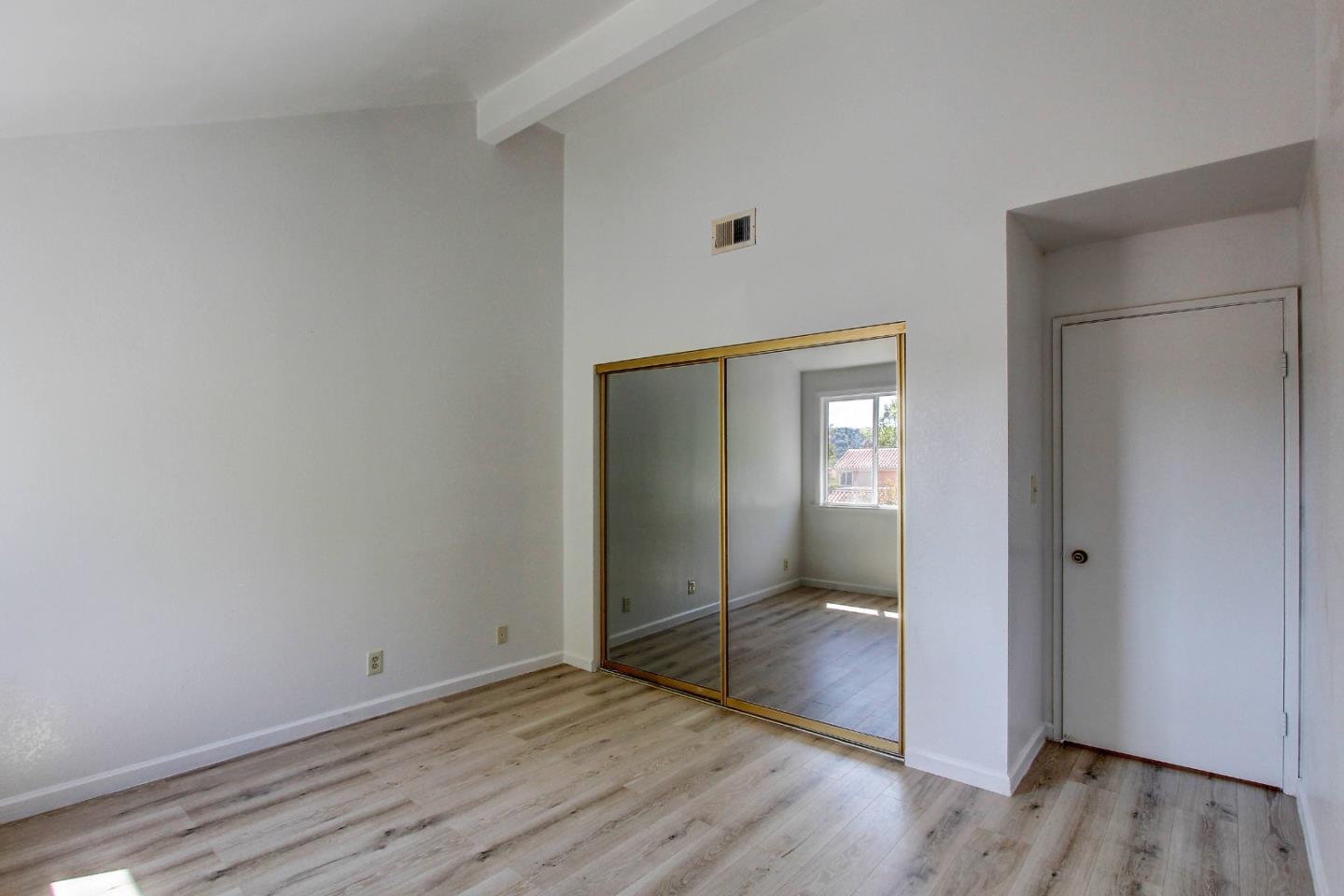 258 Paseo Bernal Moraga, CA 94556 - Photo 20 of 43 an empty room with wooden floor mirror and windows