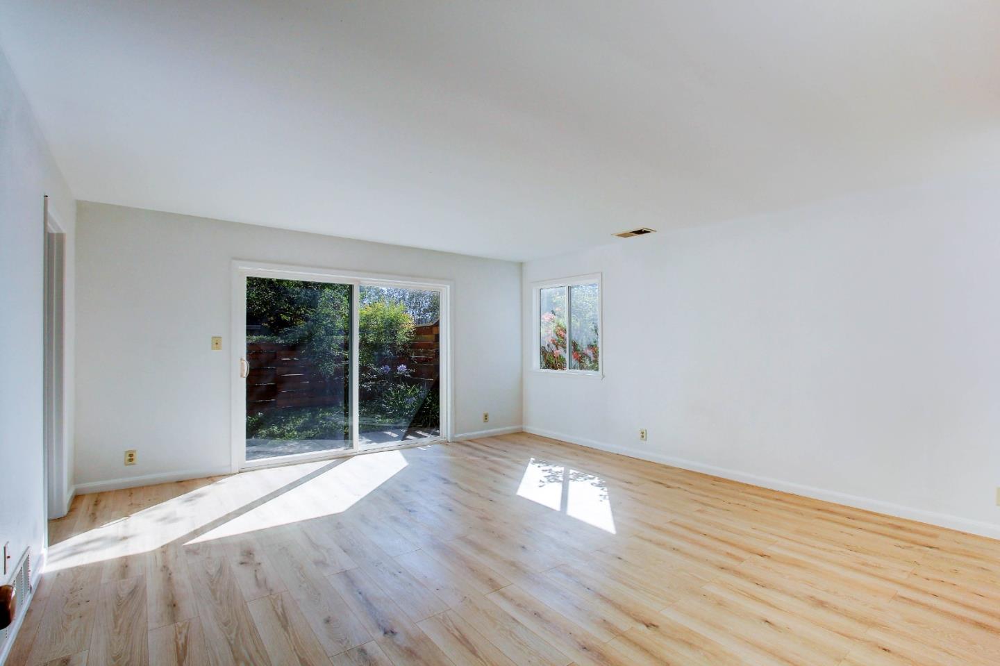 258 Paseo Bernal Moraga, CA 94556 - Photo 22 of 43 an empty room with wooden floor and windows