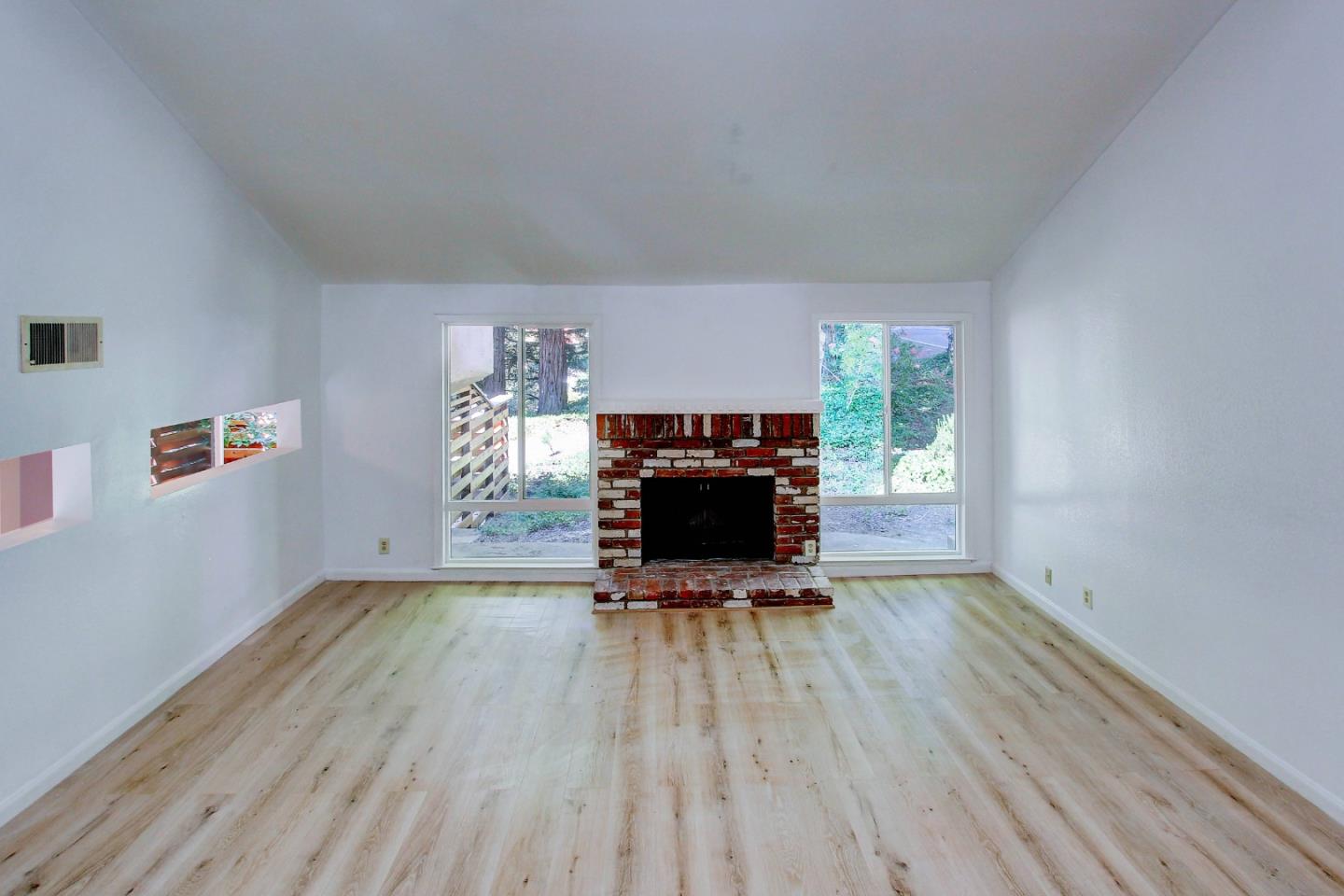 258 Paseo Bernal Moraga, CA 94556 - Photo 8 of 43 a view of empty room with wooden floor and a fireplace