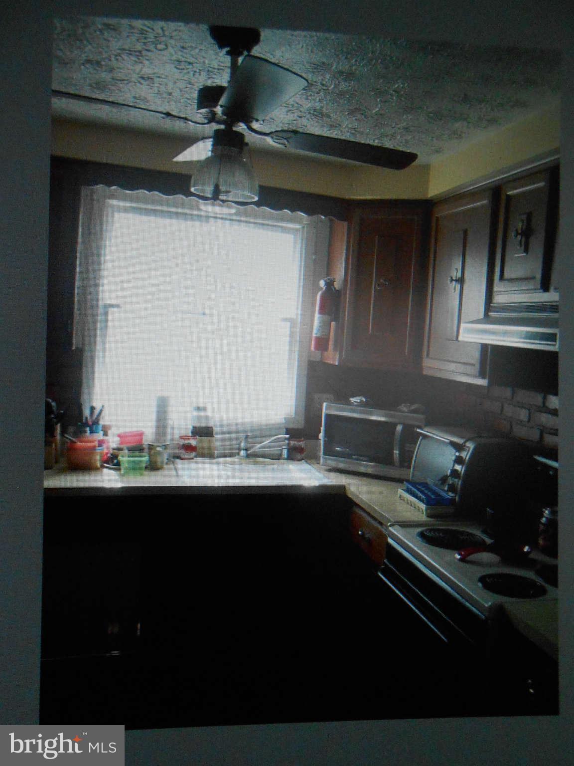 2405 Ridgely Street Baltimore, MD 21230 - Photo 2 of 4 a kitchen with a sink and cabinets