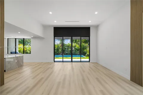 a view of an empty room with a floor to ceiling window and an outdoor view