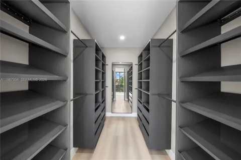a view of walk in closet with empty racks
