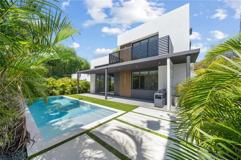 a view of the house with backyard and sitting area