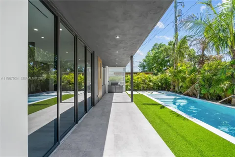 a view of a backyard with plants and a patio