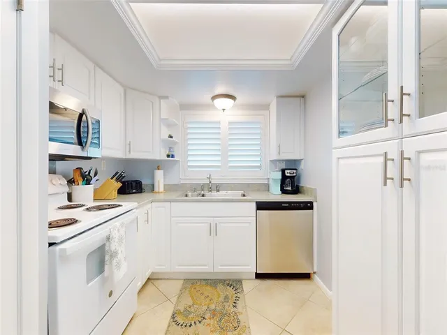 a kitchen with refrigerator cabinets and wooden floor