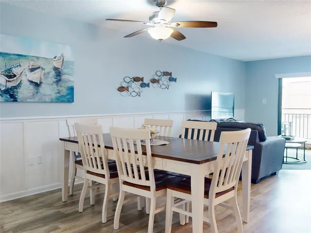 a view of a dining room with furniture and wooden floor