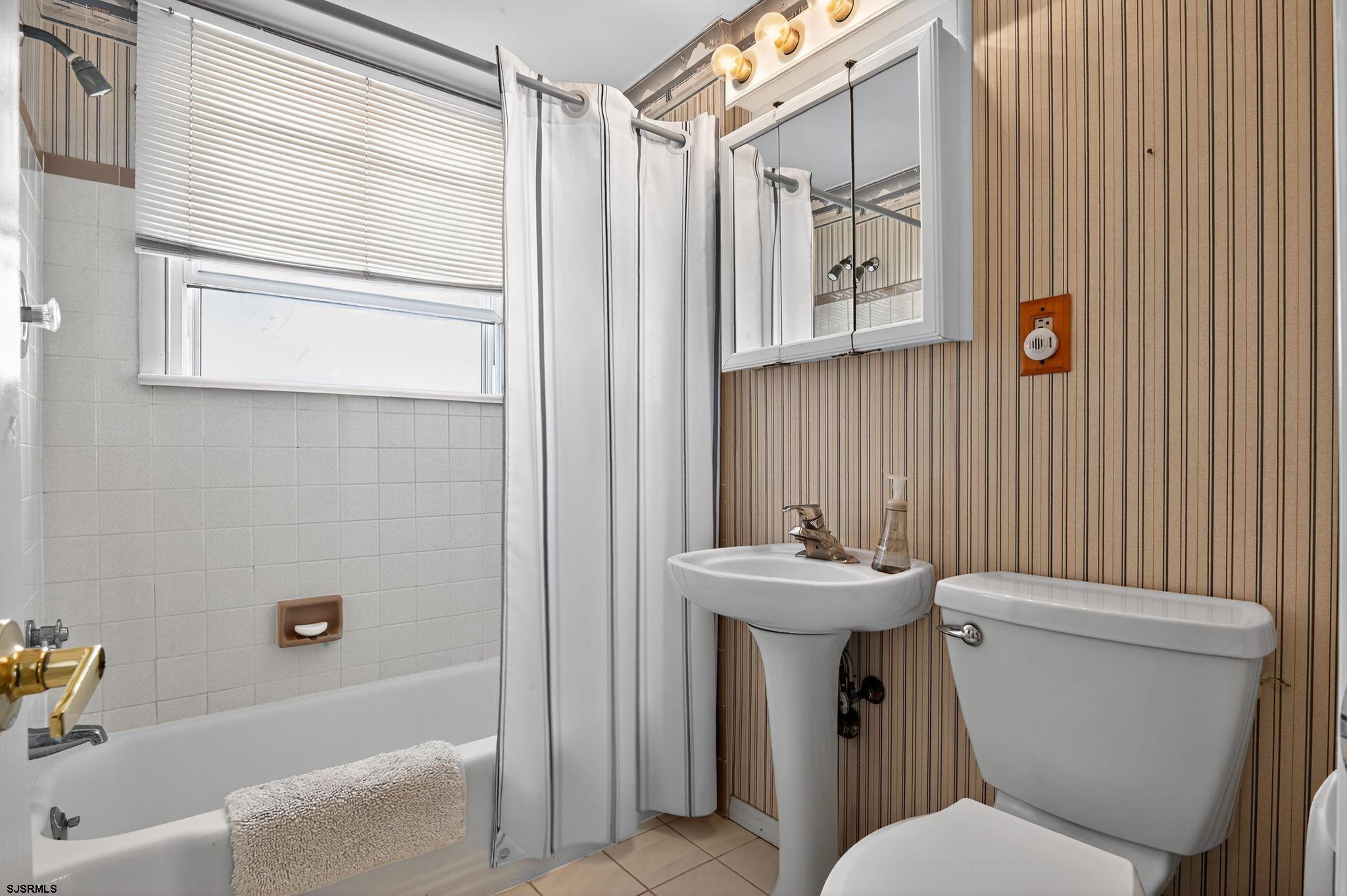 22 Williams Avenue Strathmere, NJ 08248 - Photo 23 of 40 a bathroom with a sink mirror toilet and bathtub