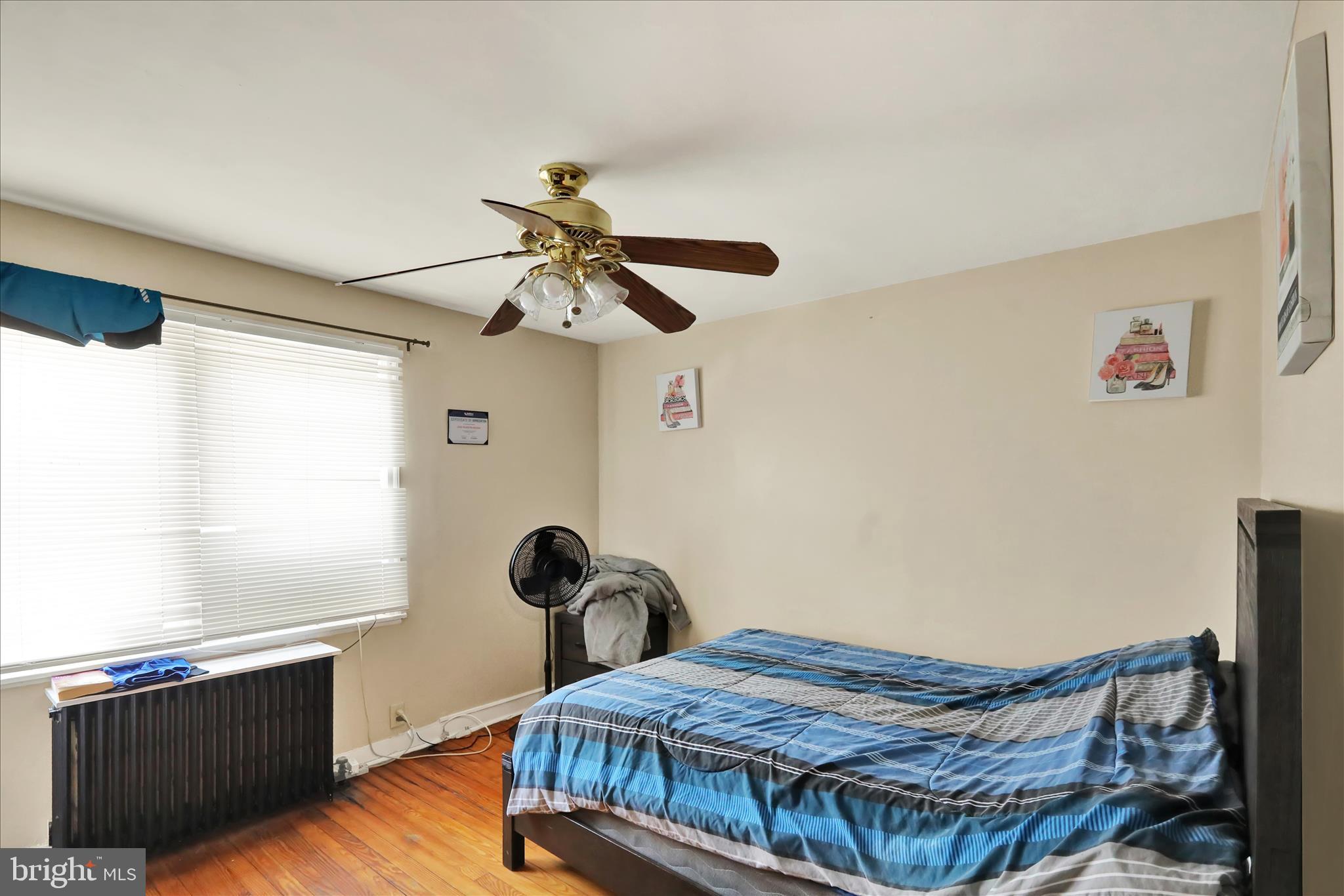 655 South Ann Street Lancaster, PA 17602 - Photo 11 of 18 a bedroom with a bed and wooden floor