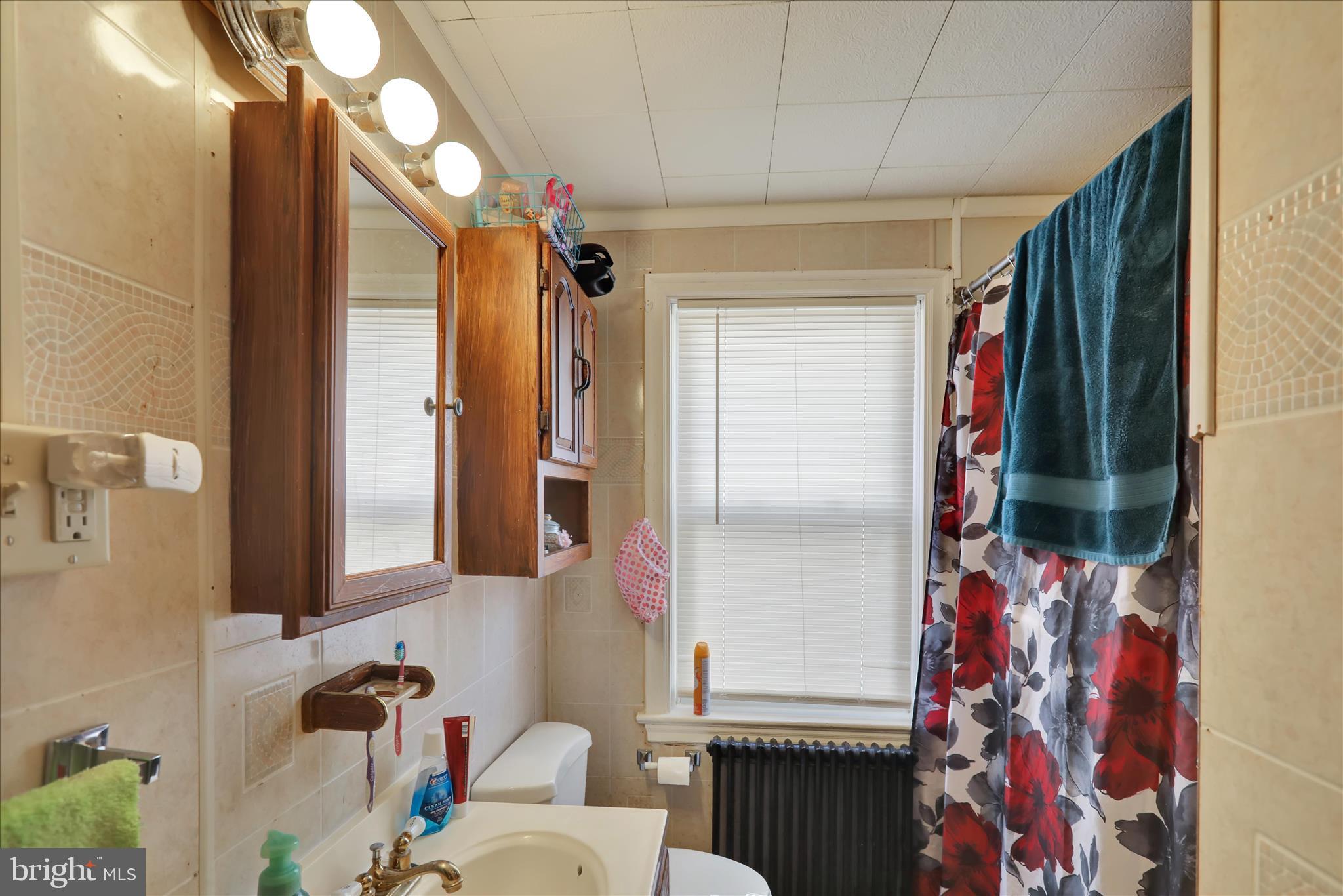 655 South Ann Street Lancaster, PA 17602 - Photo 13 of 18 a bathroom with a sink and mirror with shower
