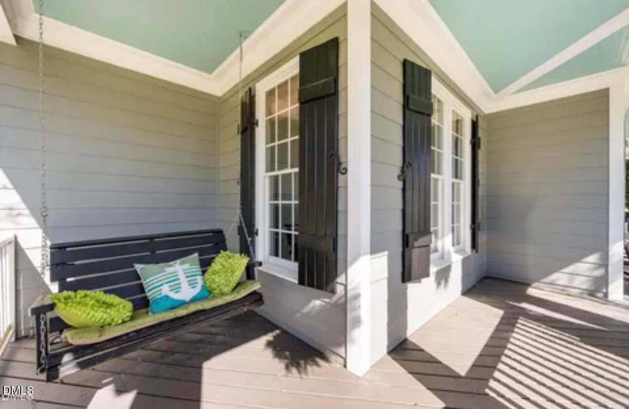 501 Wescott Ridge Drive Holly Springs, NC 27540 - Photo 3 of 52 a balcony with furniture and a potted plant