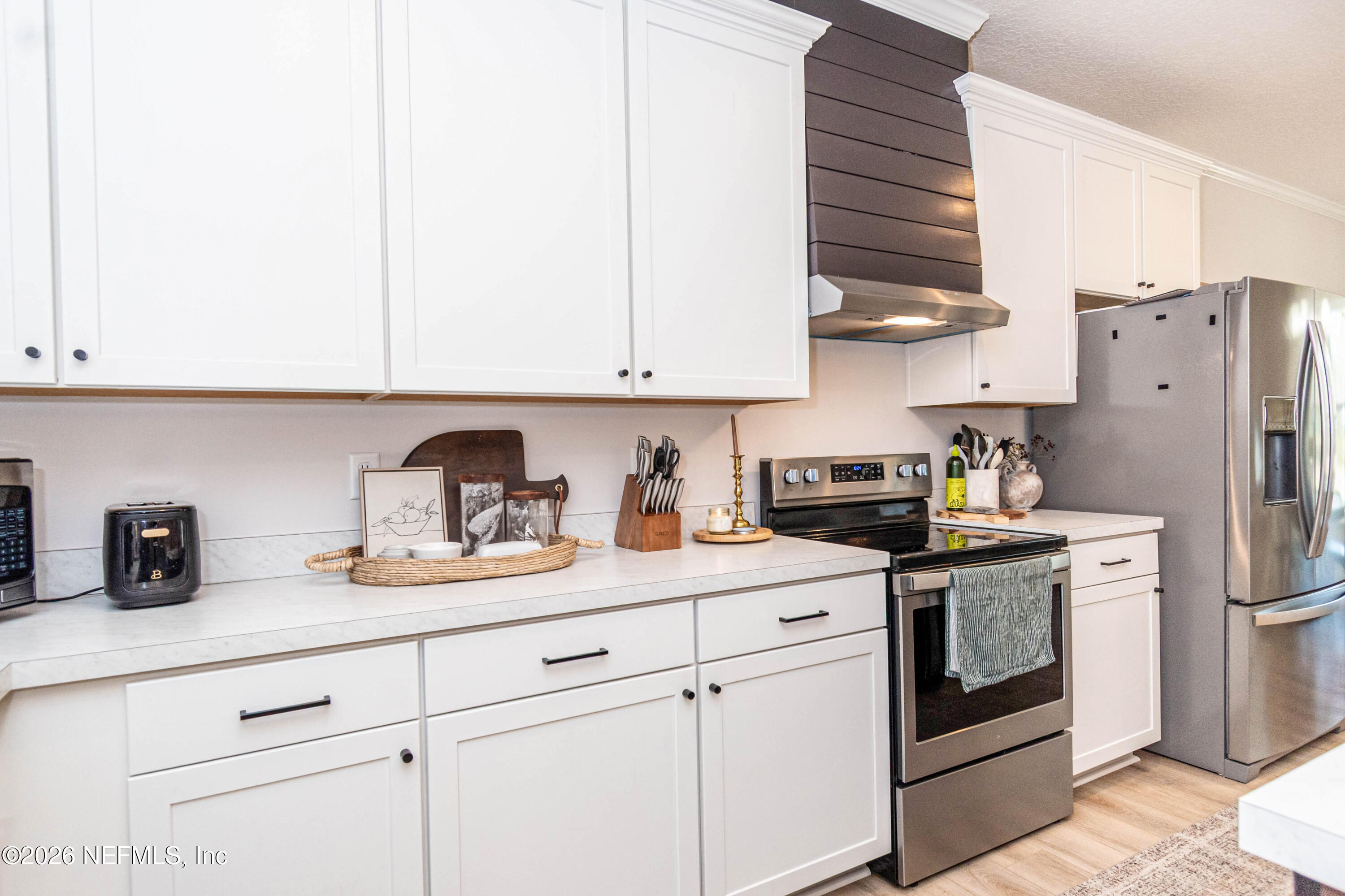 10800 Plummer Road Jacksonville, FL 32219 - Photo 15 of 67 a kitchen with stainless steel appliances granite countertop white cabinets sink and a refrigerator