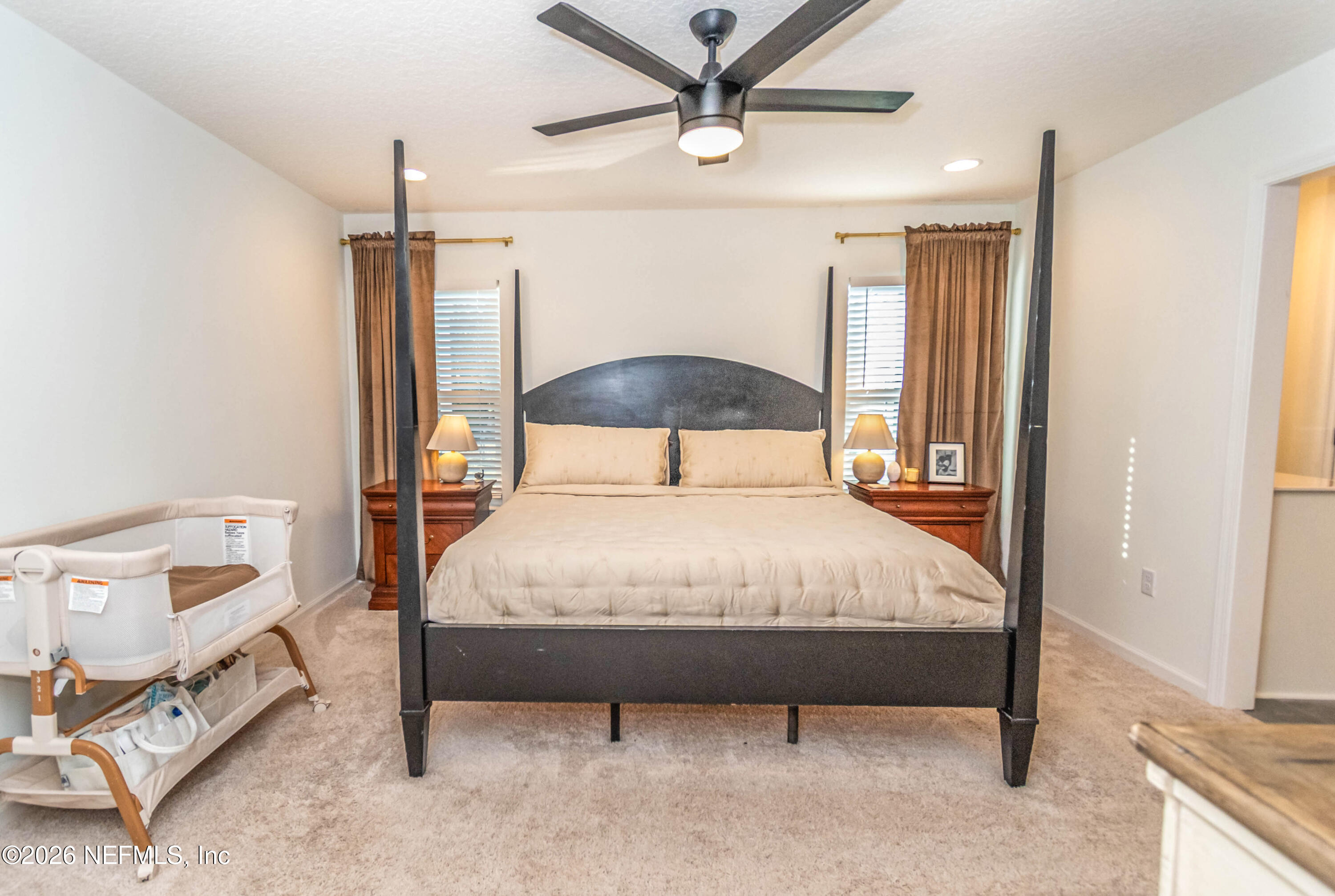 10800 Plummer Road Jacksonville, FL 32219 - Photo 18 of 67 a bedroom with a bed and a ceiling fan