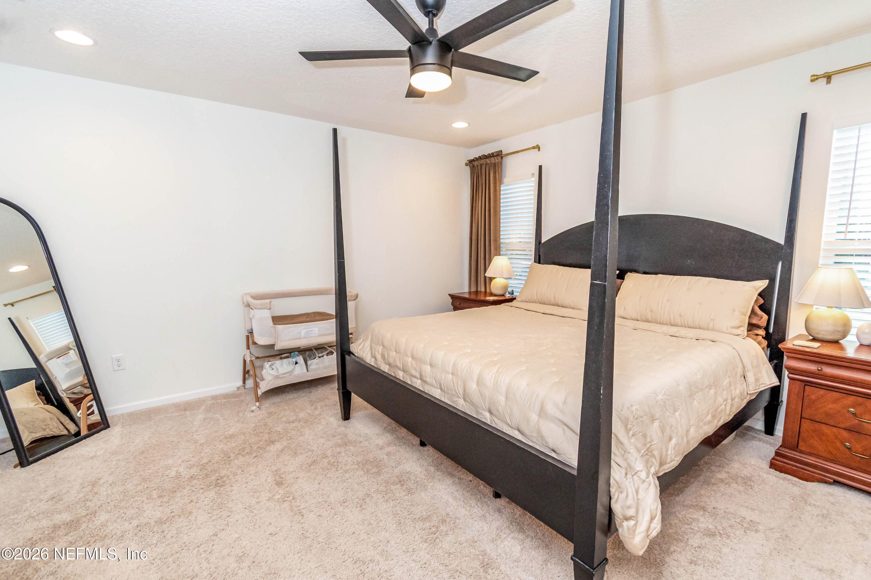 10800 Plummer Road Jacksonville, FL 32219 - Photo 19 of 67 a bedroom with a bed and a chandelier