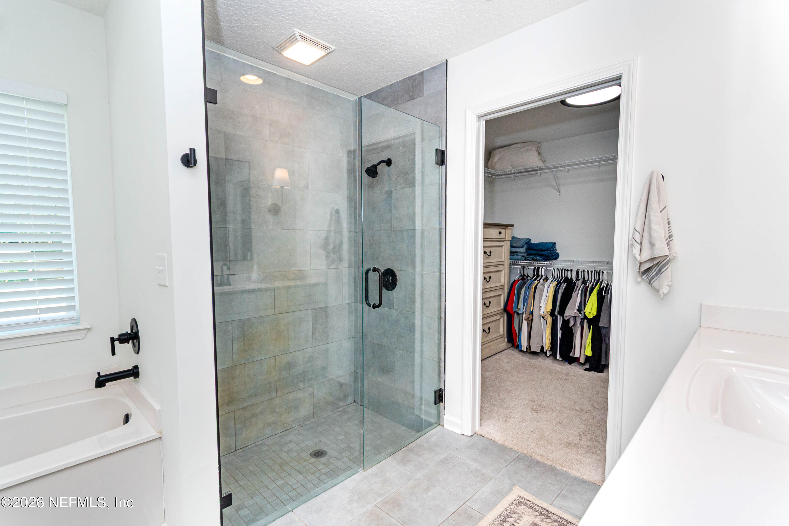 10800 Plummer Road Jacksonville, FL 32219 - Photo 22 of 67 a bathroom with a bathtub and a shower