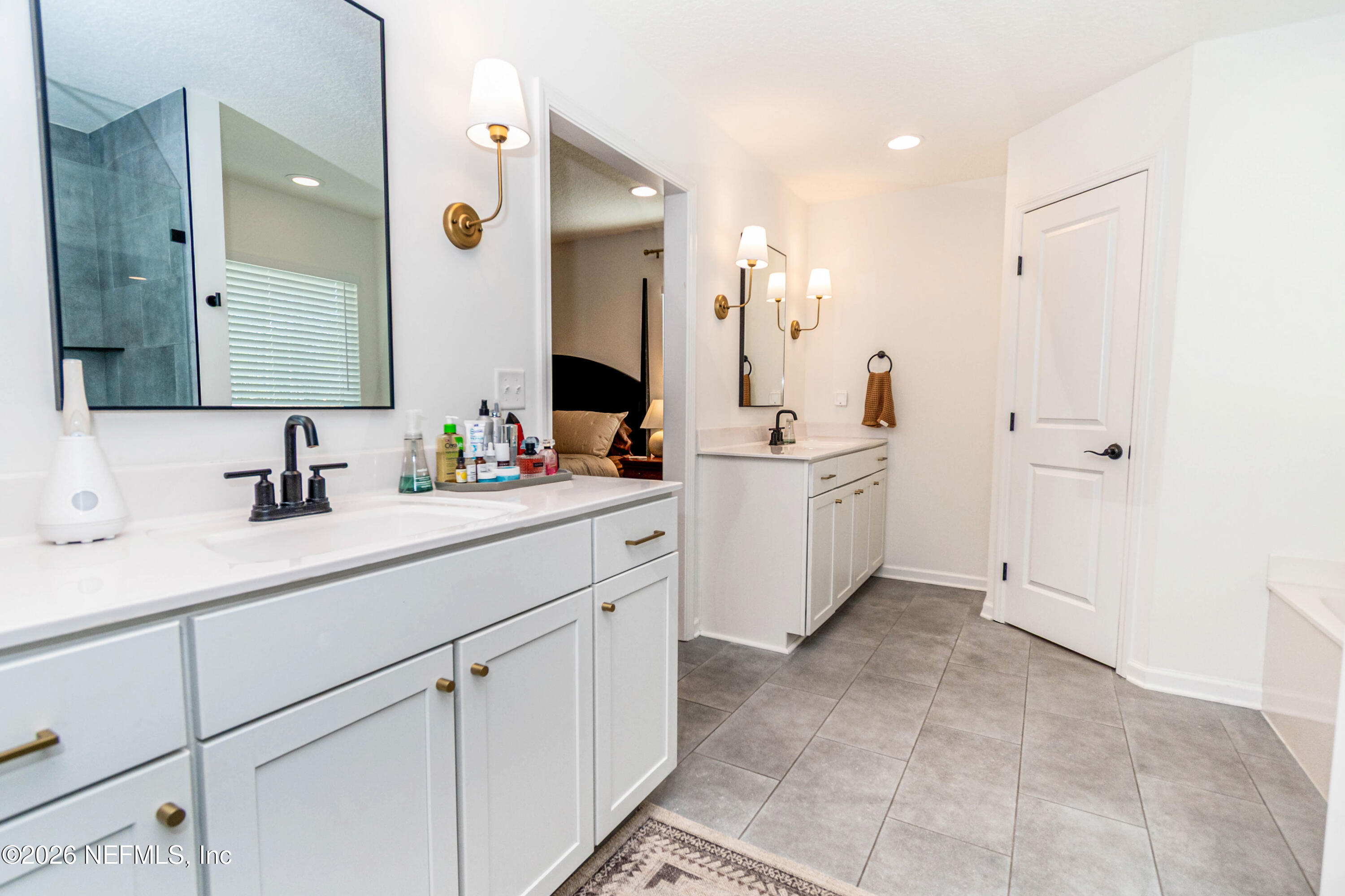10800 Plummer Road Jacksonville, FL 32219 - Photo 23 of 67 a spacious bathroom with a double vanity sink mirror and