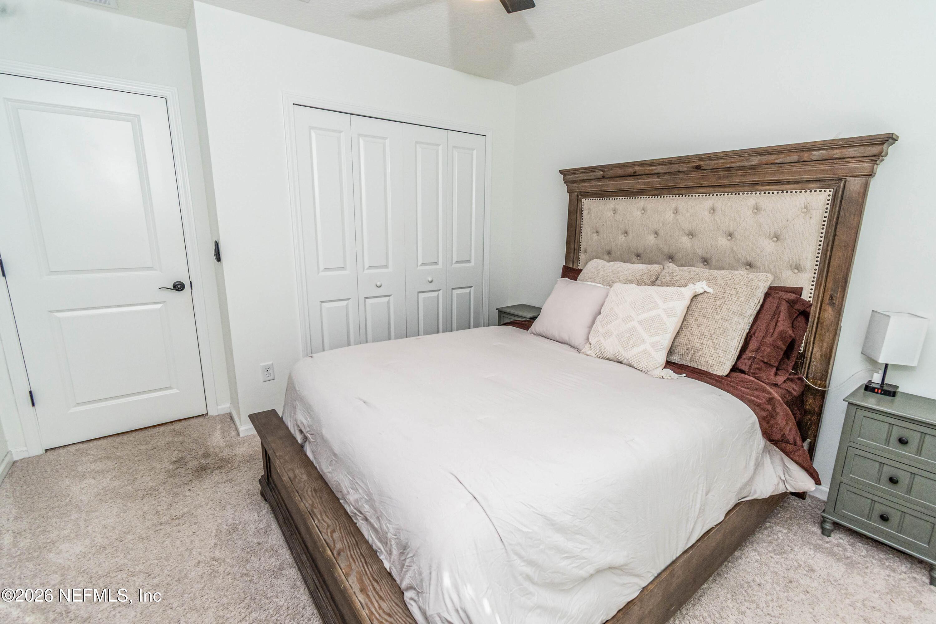 10800 Plummer Road Jacksonville, FL 32219 - Photo 33 of 67 a large bed in a bedroom next to a cabinet
