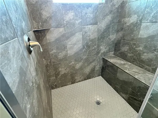 a bathroom with a granite countertop sink and vanity
