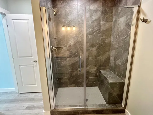 a bathroom with a glass shower door