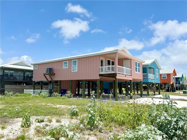 a front view of a residential apartment building with a yard