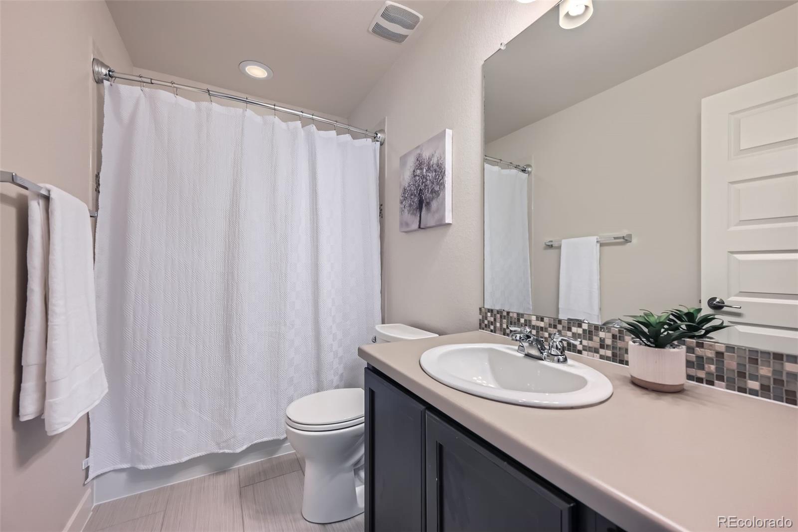 11225 Colony Circle Broomfield, CO 80021 - Photo 18 of 25 a bathroom with a sink toilet and shower