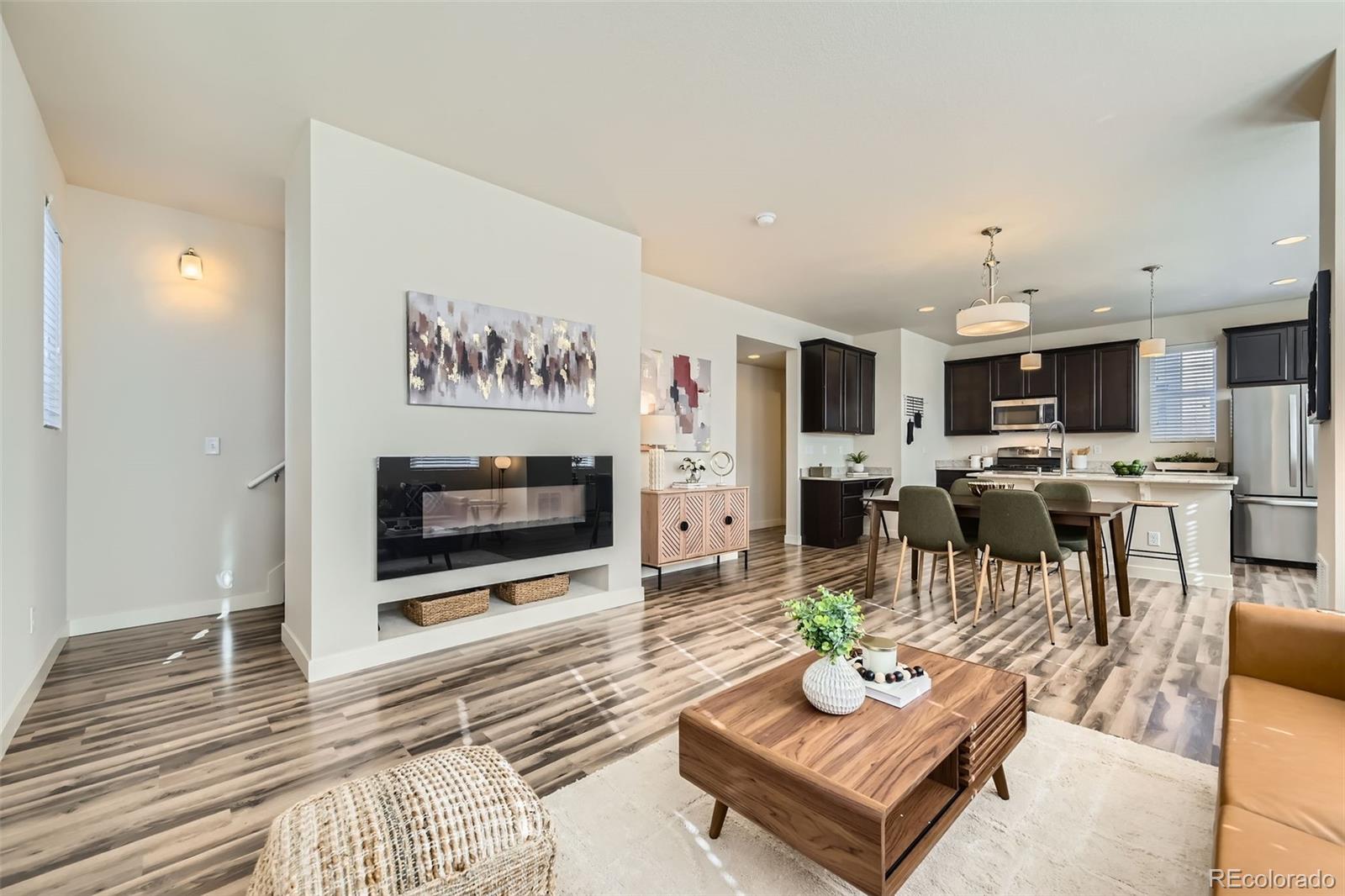 11225 Colony Circle Broomfield, CO 80021 - Photo 7 of 25 a living room with fireplace furniture and a flat screen tv