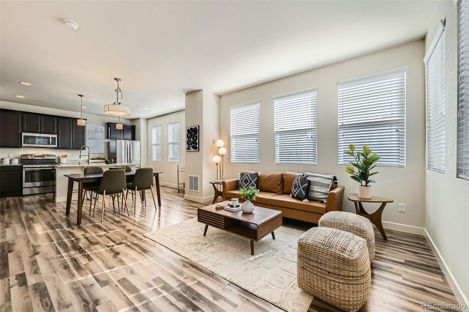 11225 Colony Circle Broomfield, CO 80021 - Photo 8 of 25 a living room with furniture and a wooden floor