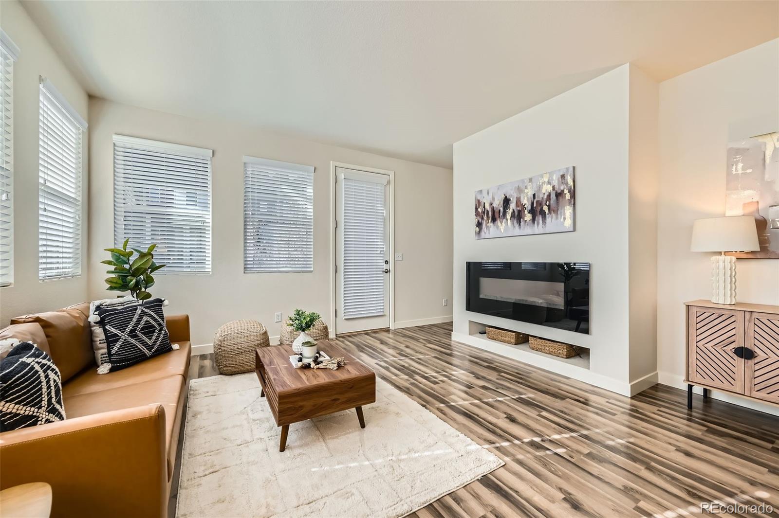 11225 Colony Circle Broomfield, CO 80021 - Photo 9 of 25 a living room with furniture and a flat screen tv