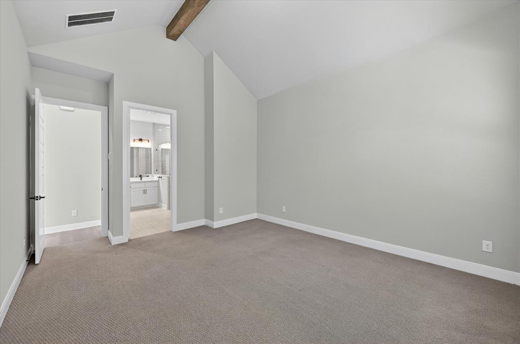2237 Pika Road Northlake, TX 76247 - Photo 17 of 37 Spacious room featuring vaulted ceilings with a wood beam, light grey wall paint, and grey carpet flooring