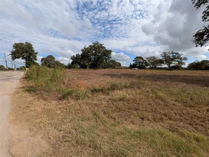 a view of a houses with yard and ocean view