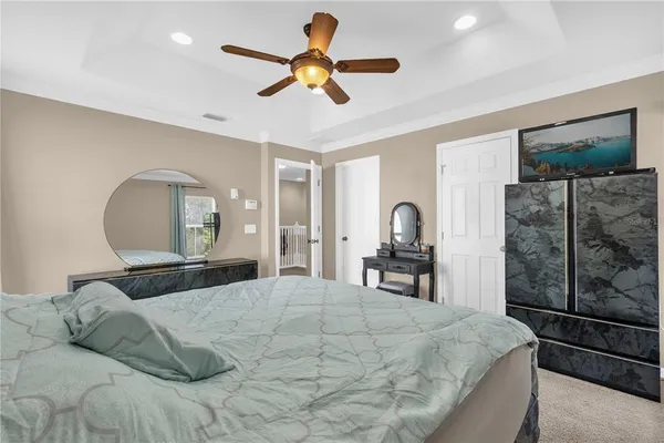 a bedroom with a bed mirror and window