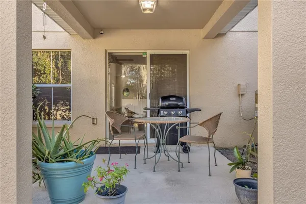 a dining room with furniture and potted plants