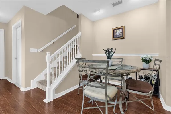 a view of a dining room with furniture and wooden floor