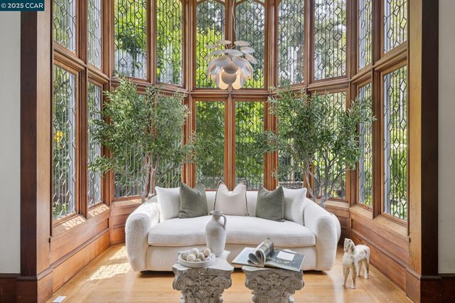 a living room with large windows and furniture