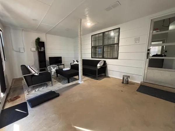a living room with furniture a fireplace and a large window