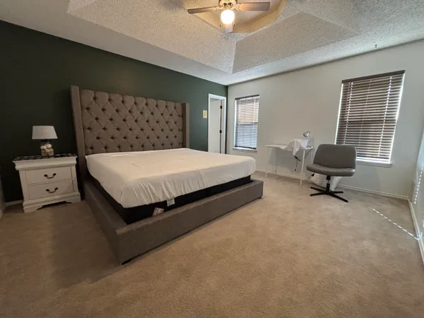 a bed room with a bed and a chair
