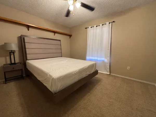 a bedroom with a bed and a table