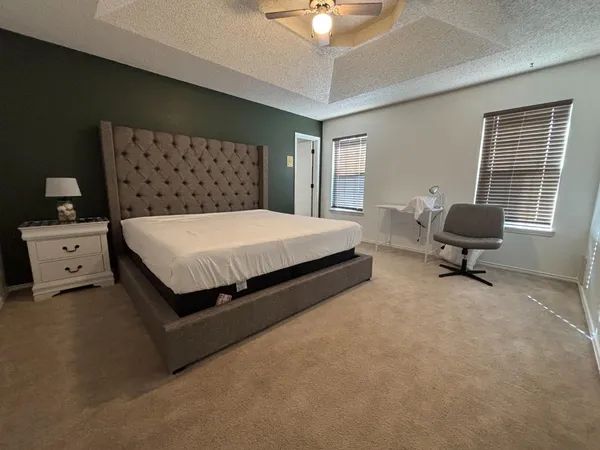 a bed room with a bed and a chair