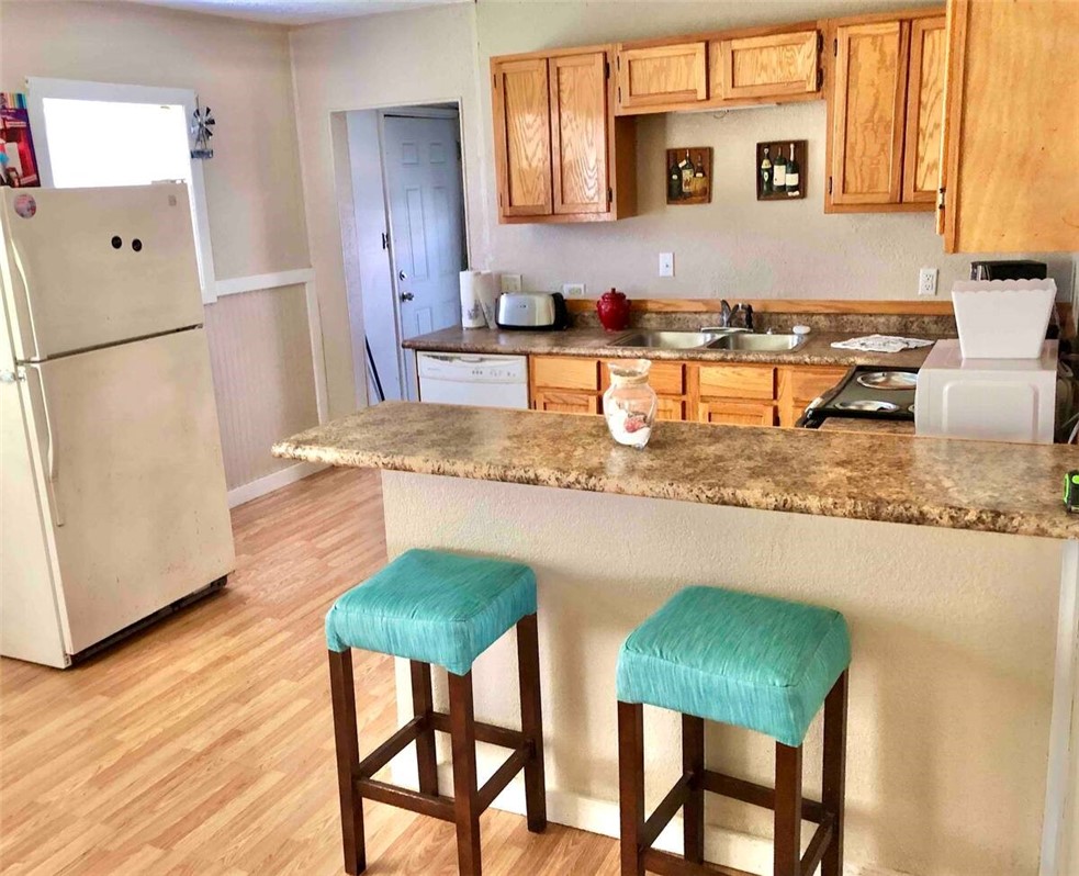2580 5th Street Ingleside, TX 78362 - Photo 20 of 28 a kitchen with stainless steel appliances granite countertop a table chairs sink and cabinets