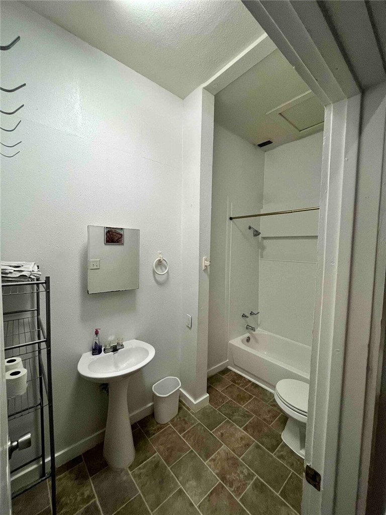 2580 5th Street Ingleside, TX 78362 - Photo 24 of 28 a bathroom with a sink toilet and shower