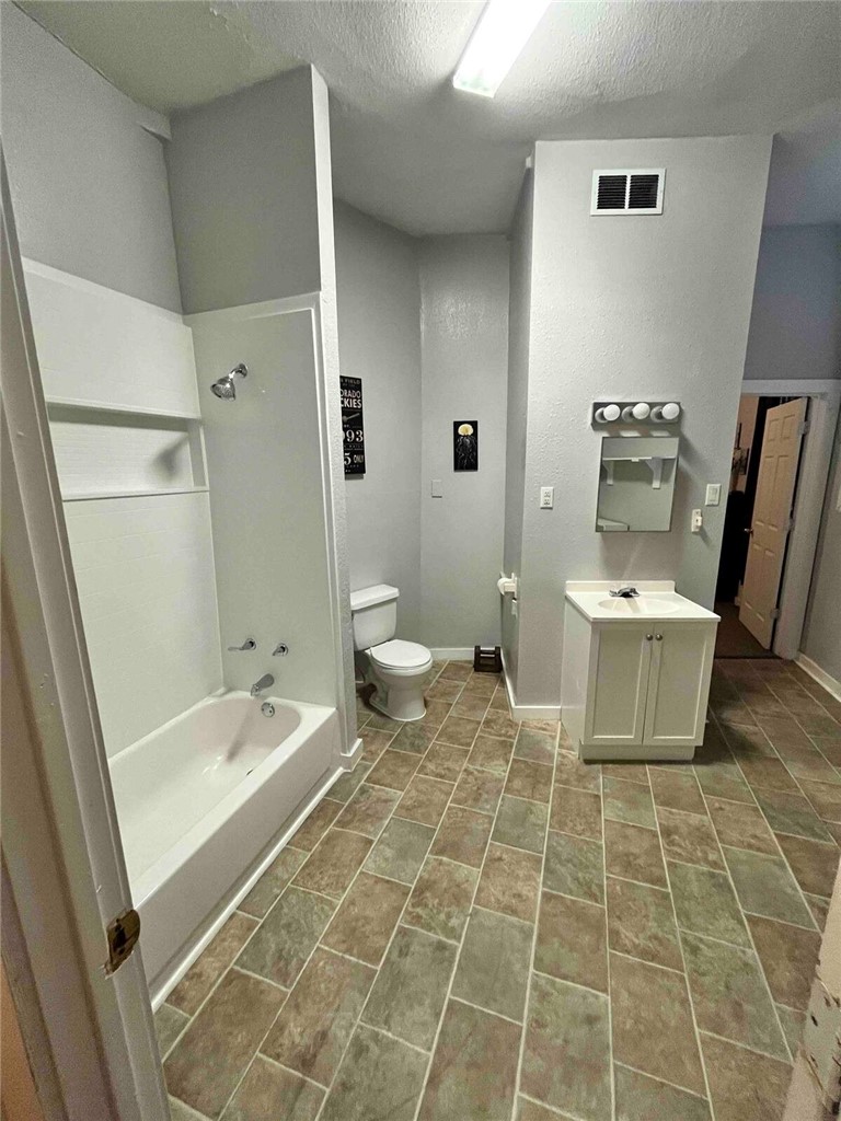 2580 5th Street Ingleside, TX 78362 - Photo 27 of 28 a bathroom with a toilet and a shower