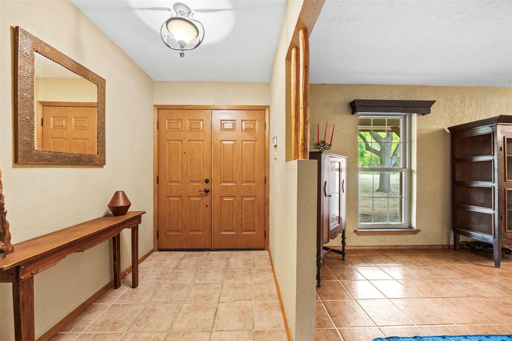 505 Curtis Road Burleson, TX 76028 - Photo 15 of 19 a view of a hallway with wooden floor and a bathroom