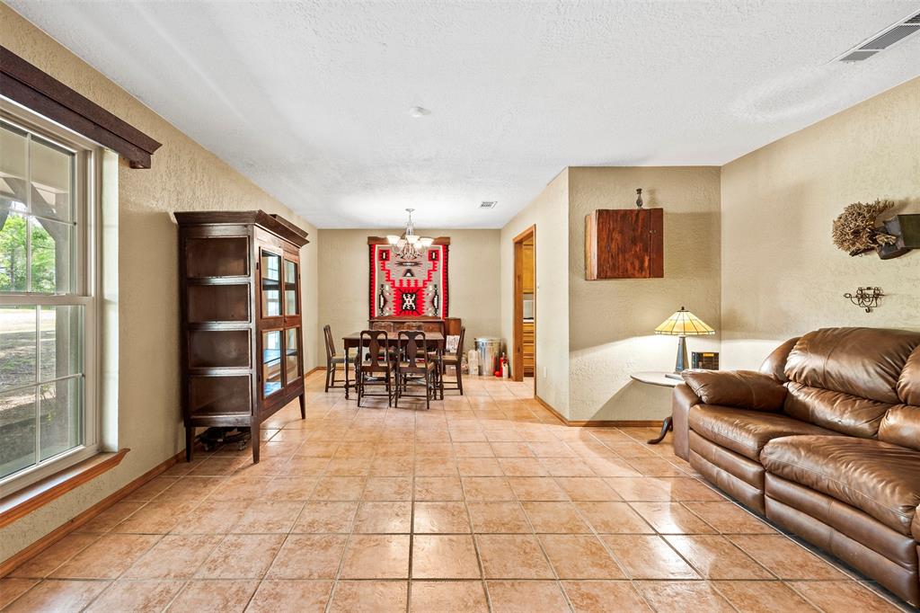 505 Curtis Road Burleson, TX 76028 - Photo 17 of 19 a living room with furniture a dining table and a large window