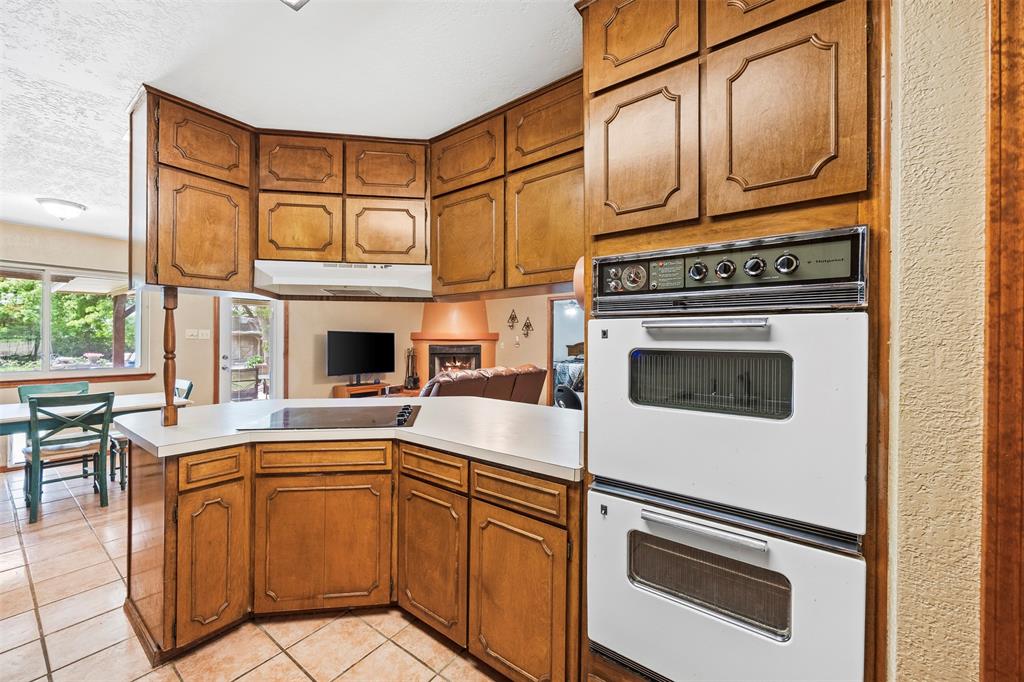 505 Curtis Road Burleson, TX 76028 - Photo 18 of 19 a kitchen with stainless steel appliances granite countertop a stove a sink and a refrigerator