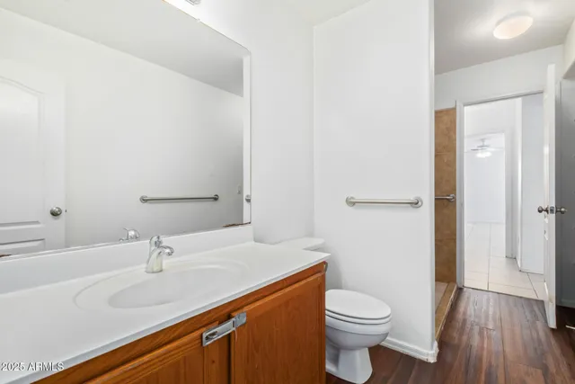 a bathroom with a sink a toilet and shower